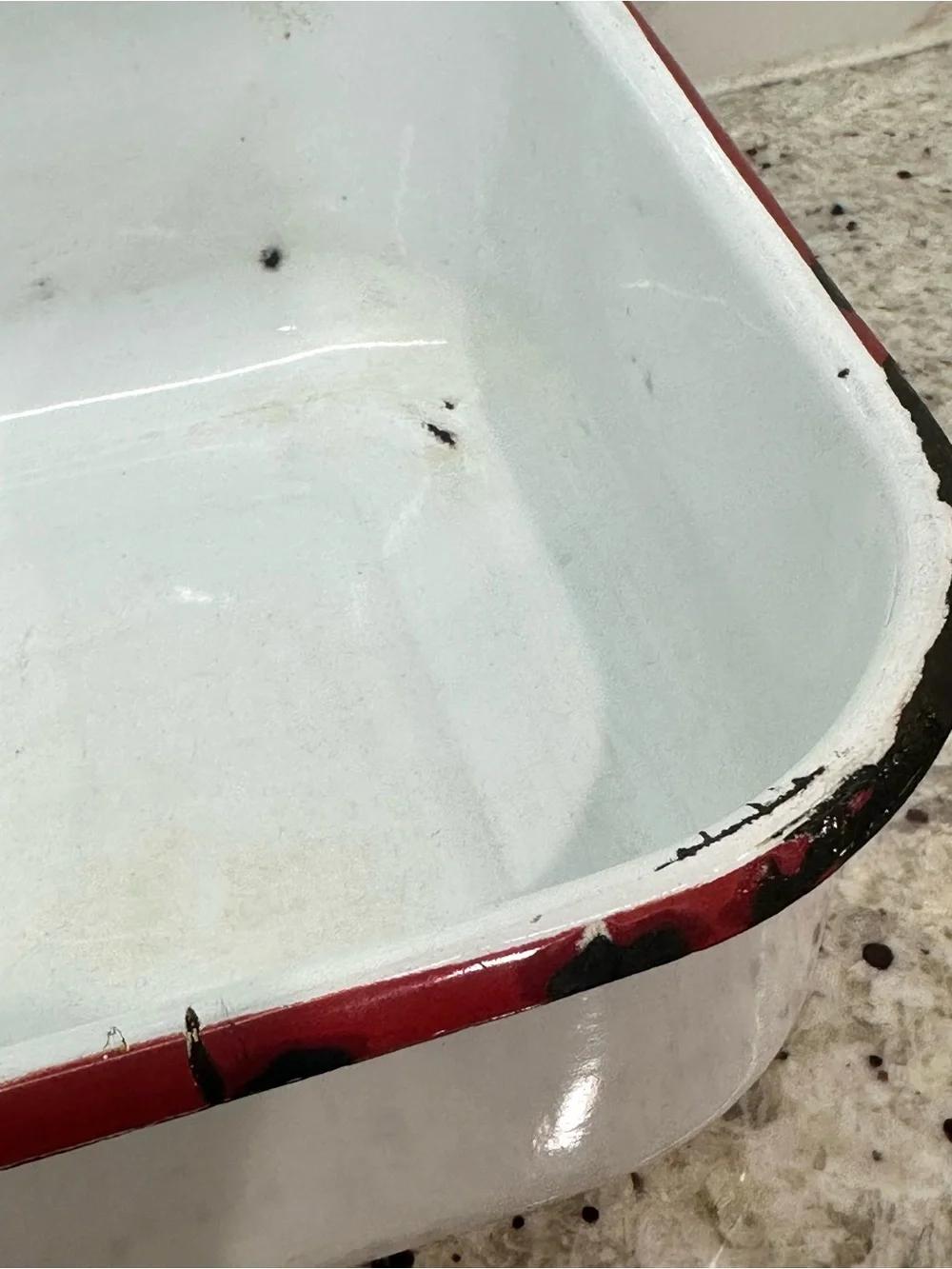 Vintage white enamel pan with red trim